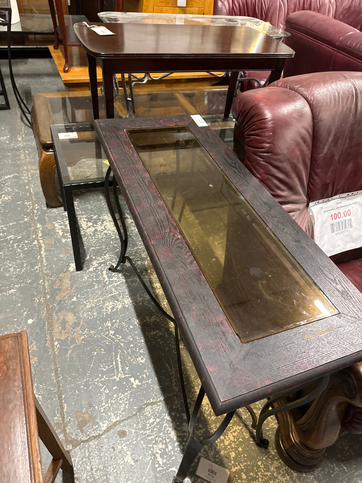 Black metal framed console table, dark wood top, frosted glass centre