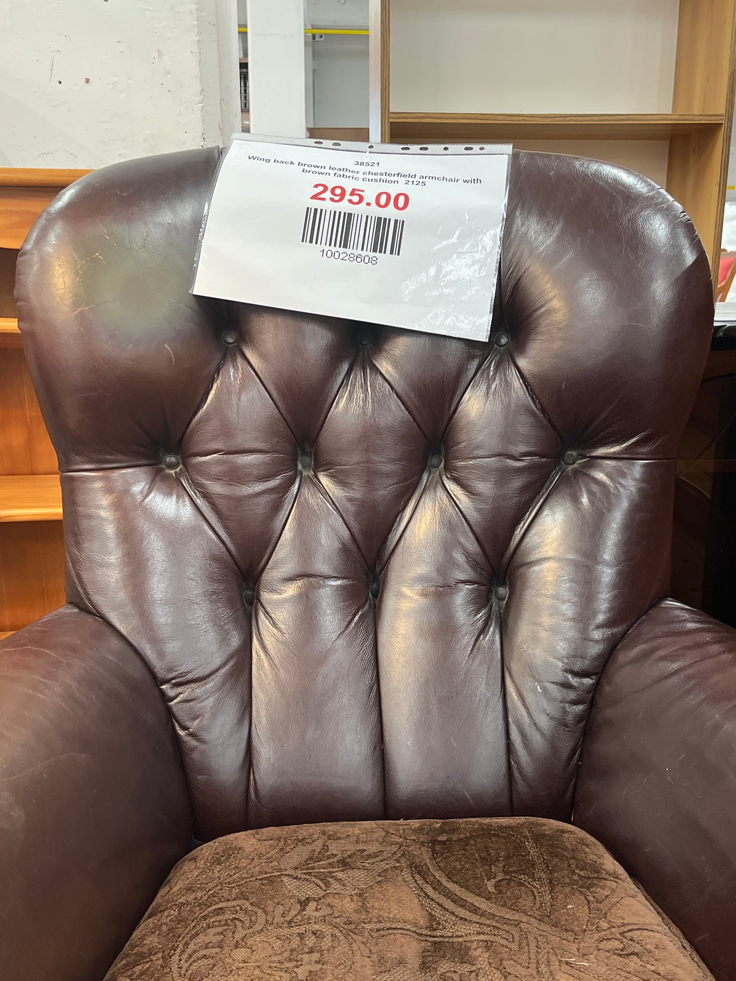 Wing back brown leather chesterfield armchair with brown fabric cushion  2125