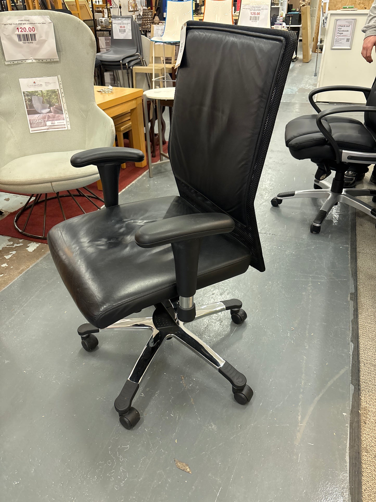 High back black leather and mesh executive swivel chair with polished metal base and height adjustable arms