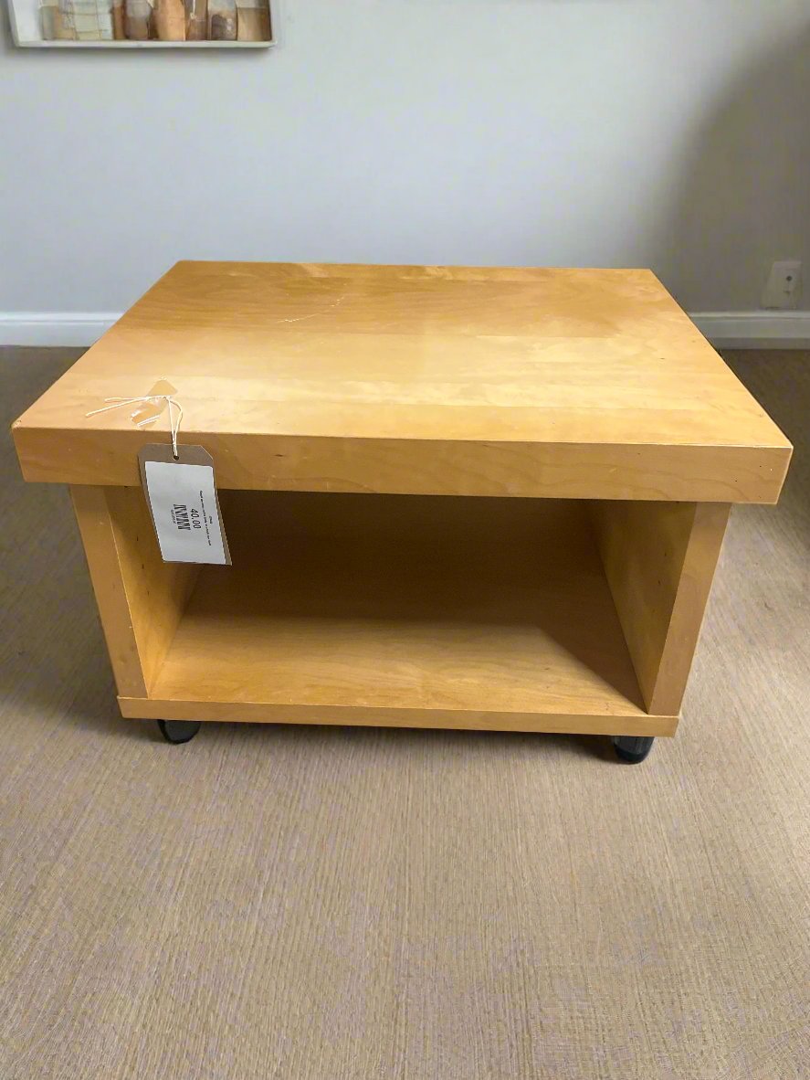 Small wooden coffee table on wheels one shelf