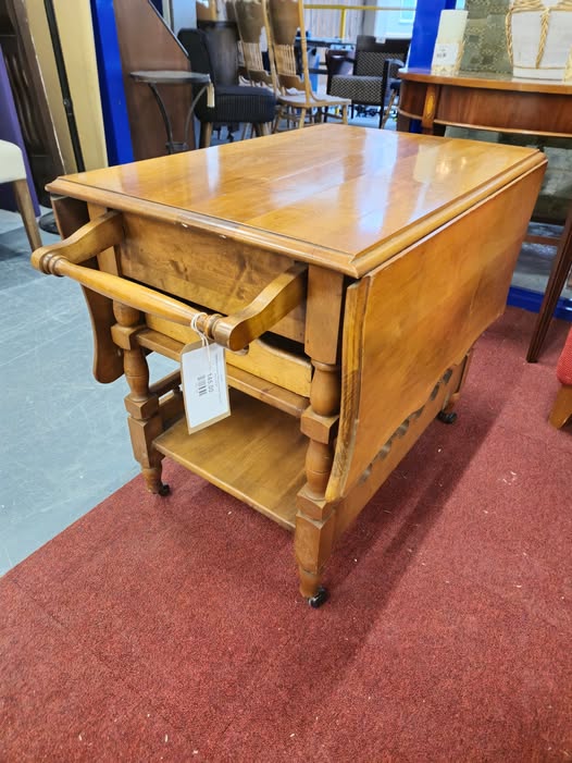 Ornate wood drop leaf trolley with shelves, drawer and tray on castors