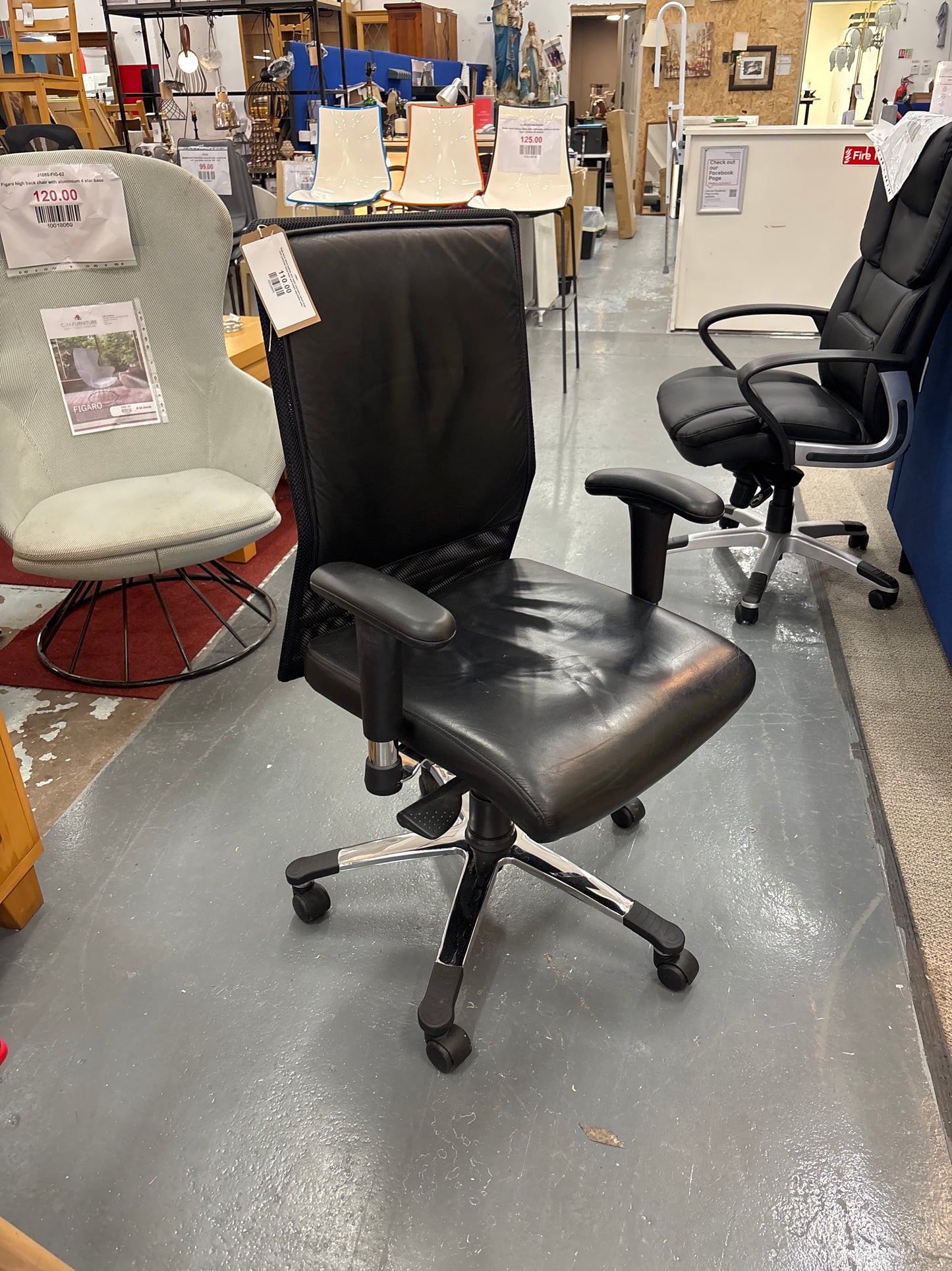 High back black leather and mesh executive swivel chair with polished metal base and height adjustable arms