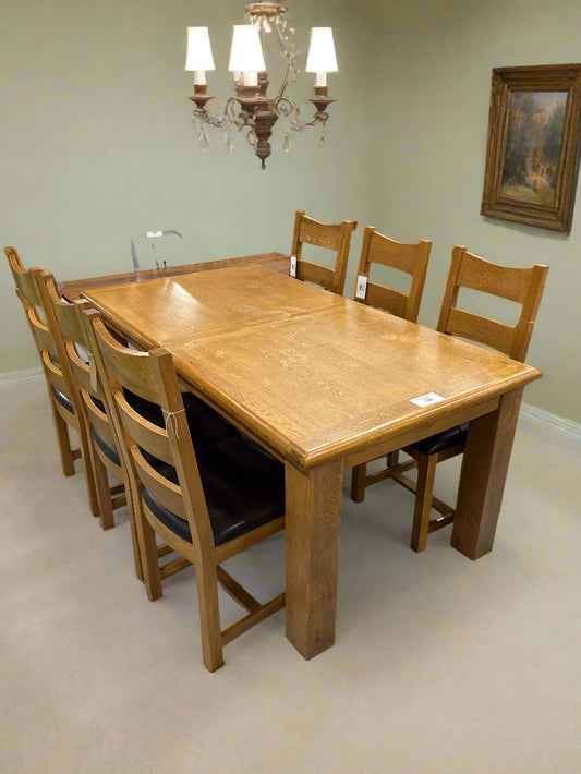 Solid oak extendable dining table with 6 no. chairs with black leatherette seat  2125