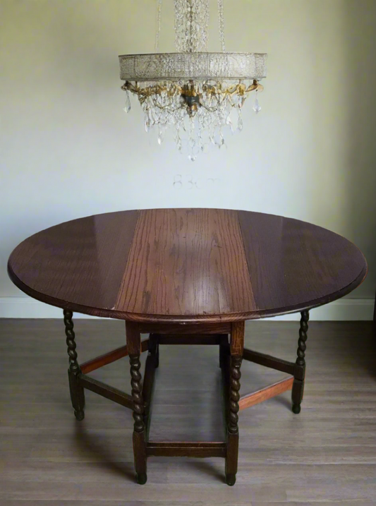 Dark wood drop leaf oval table with swirl legs 3124