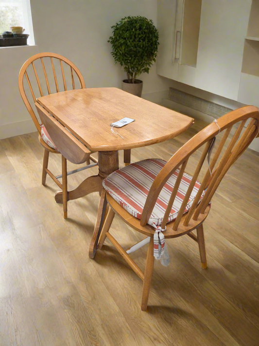 Circular hardwood drop leaf kitchen table with central base%A0comes with 2 spoonback solid kitchen chairs 1125