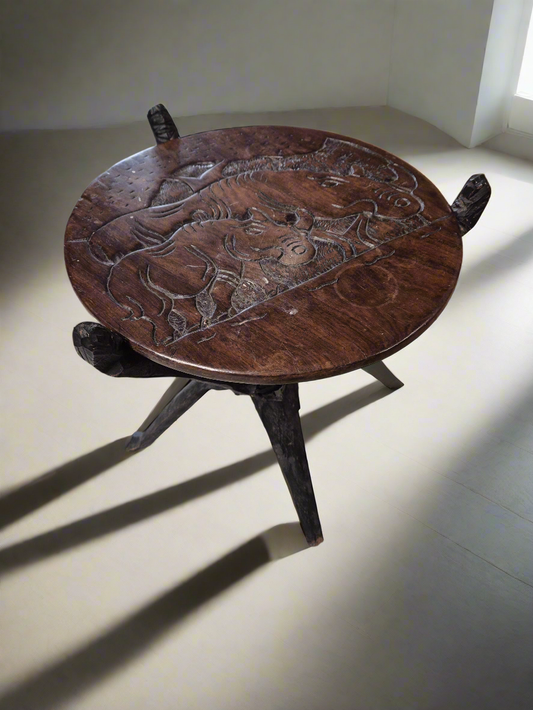 Small ornate tripod circular table by TV  1125