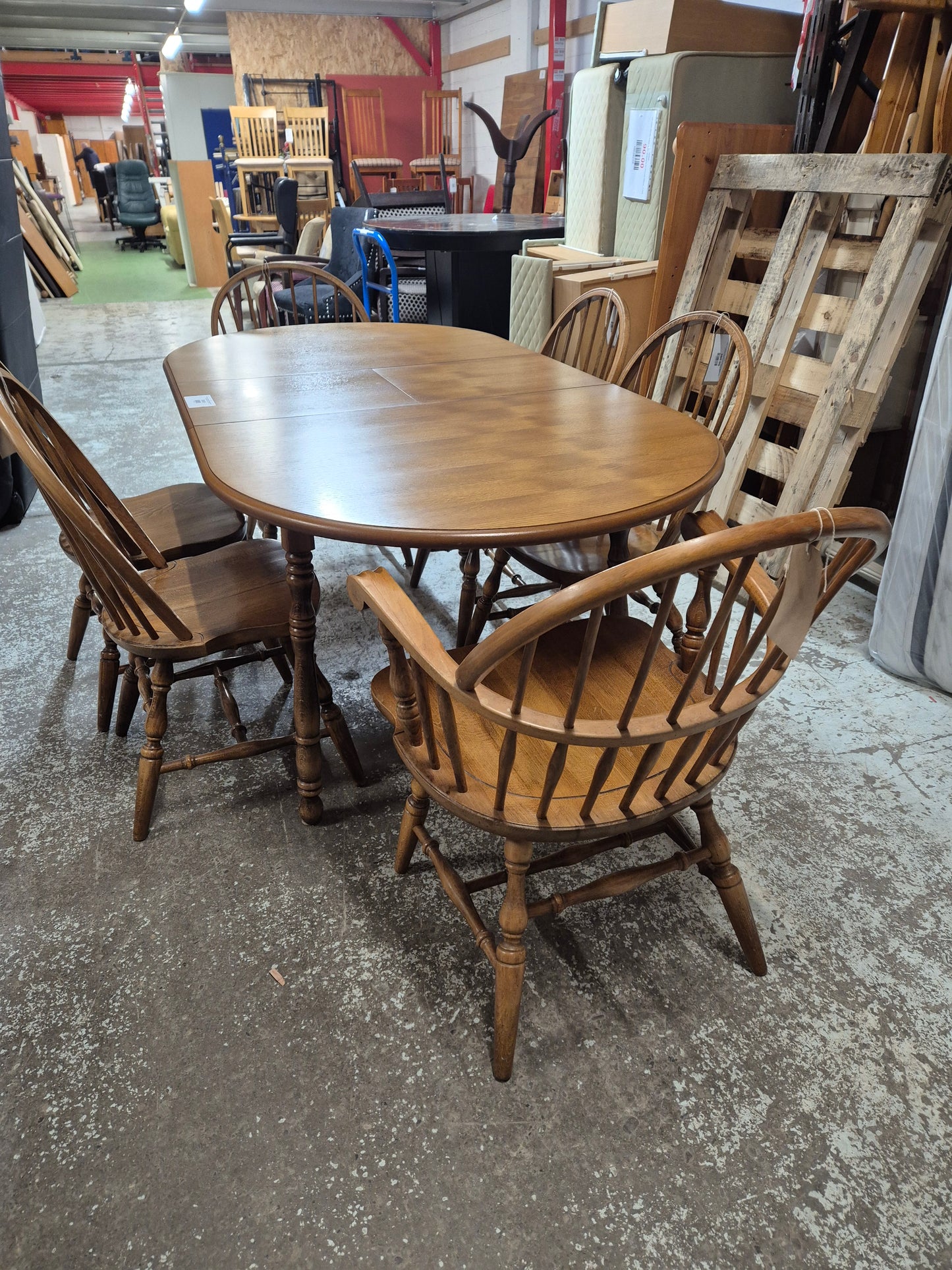 Solid oak stained extendable oval kitchen table with 4 no. matching chairs and 2 no. carvers  2125