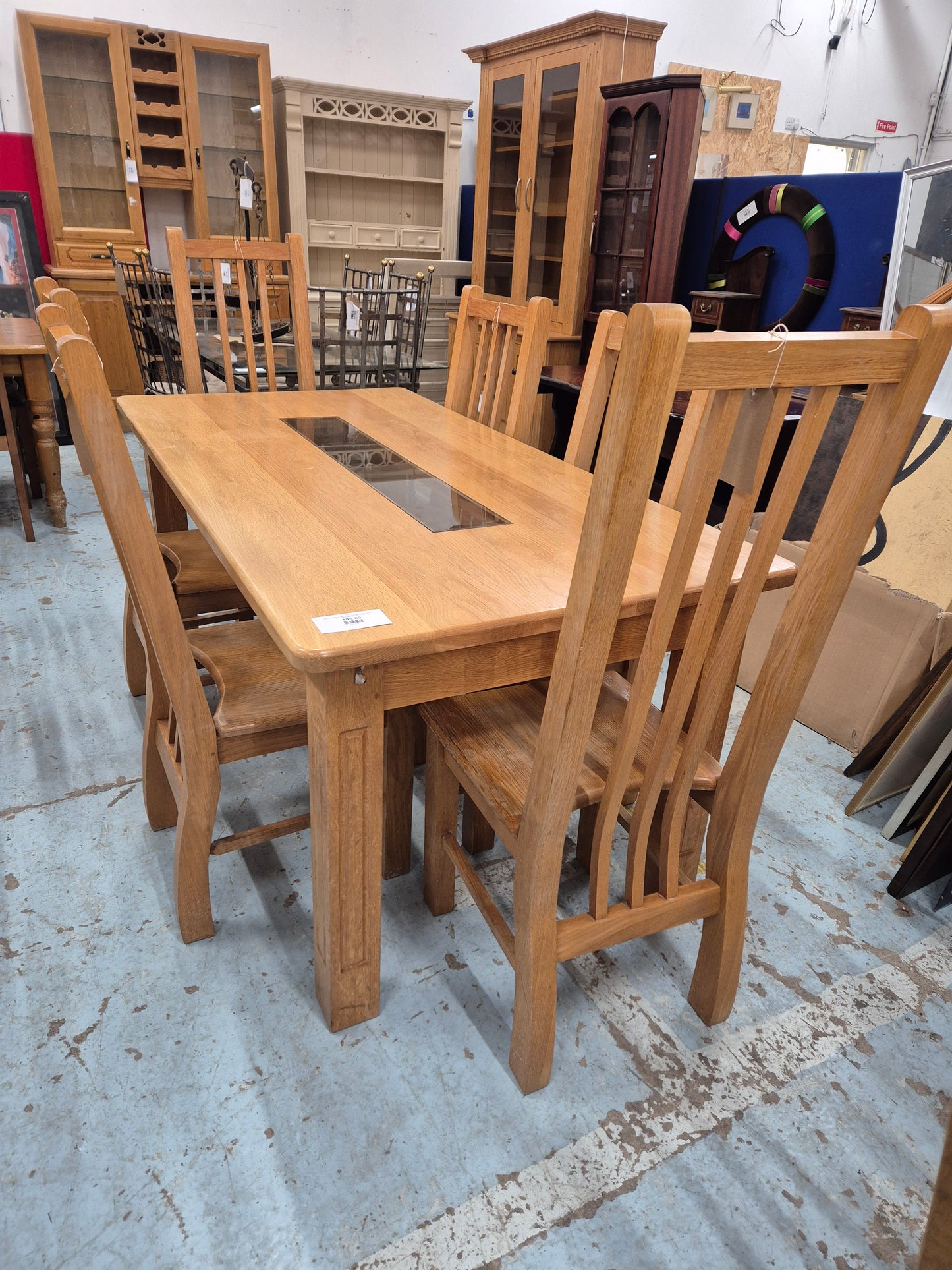 Solid oak kitchen table with central glass insert and 6 no solid wood matching chairs  1125