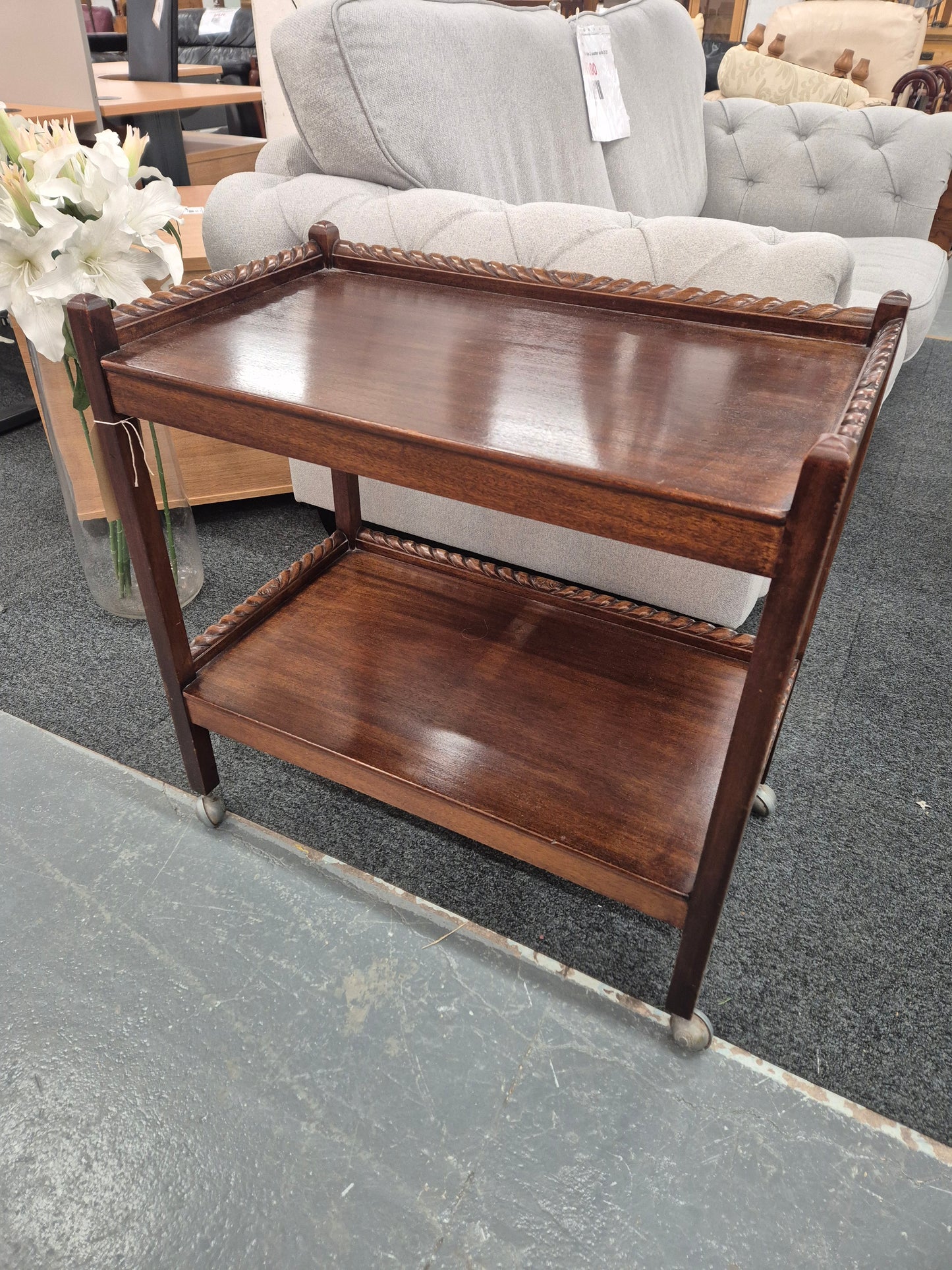 Tall mahogany tiered drinks trolley on castors 