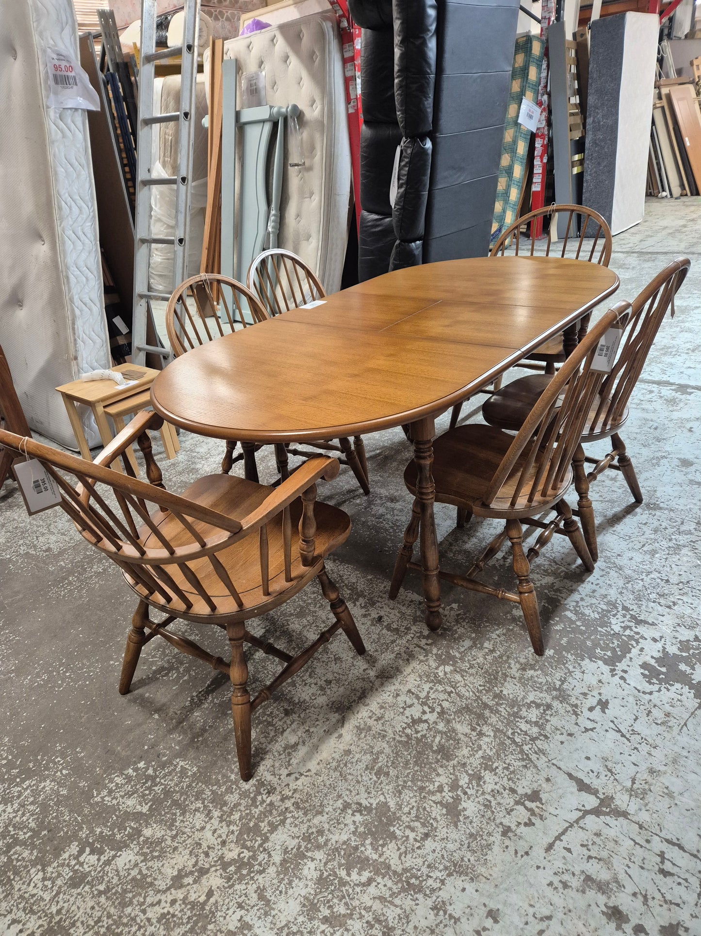 Solid oak stained extendable oval kitchen table with 4 no. matching chairs and 2 no. carvers  2125