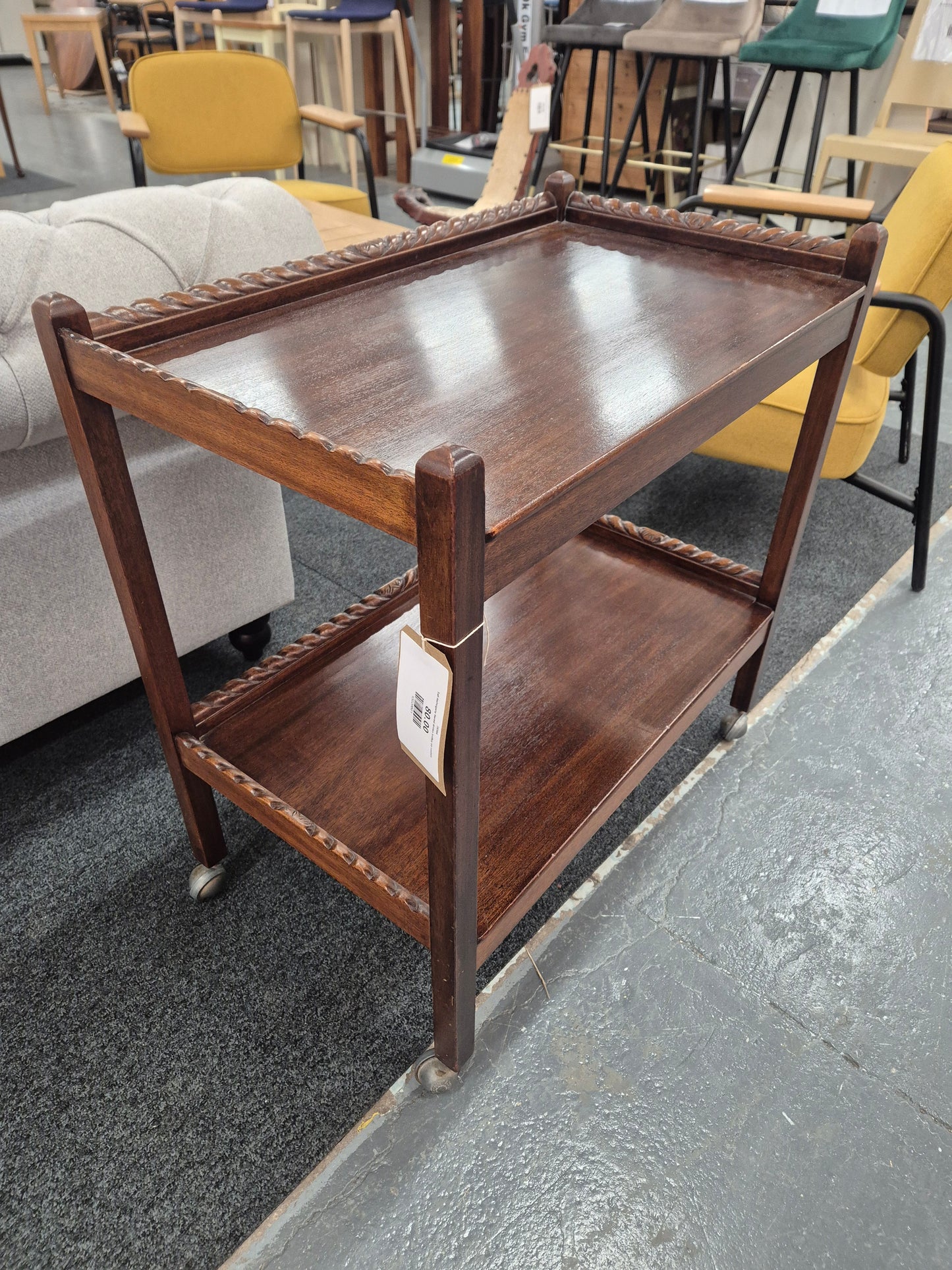 Tall mahogany tiered drinks trolley on castors 