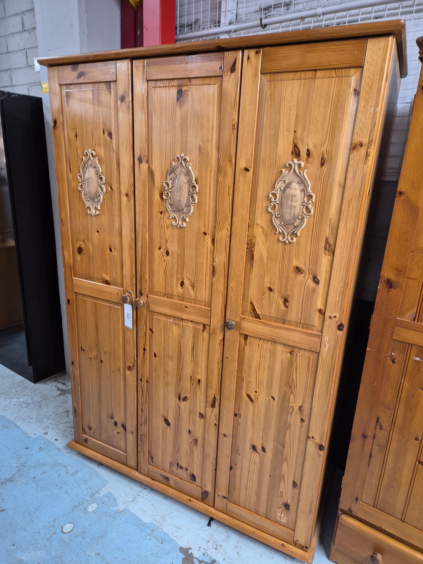 Tall 3 door solid pine wardrobe with wooden detail on door panels  4224