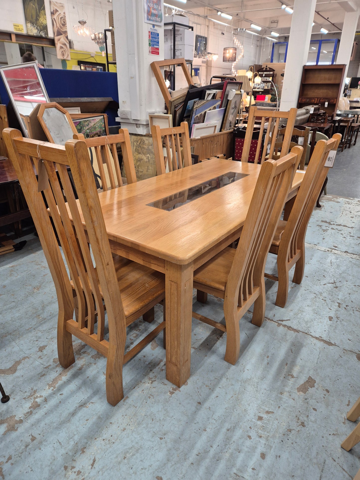 Solid oak kitchen table with central glass insert and 6 no solid wood matching chairs  1125