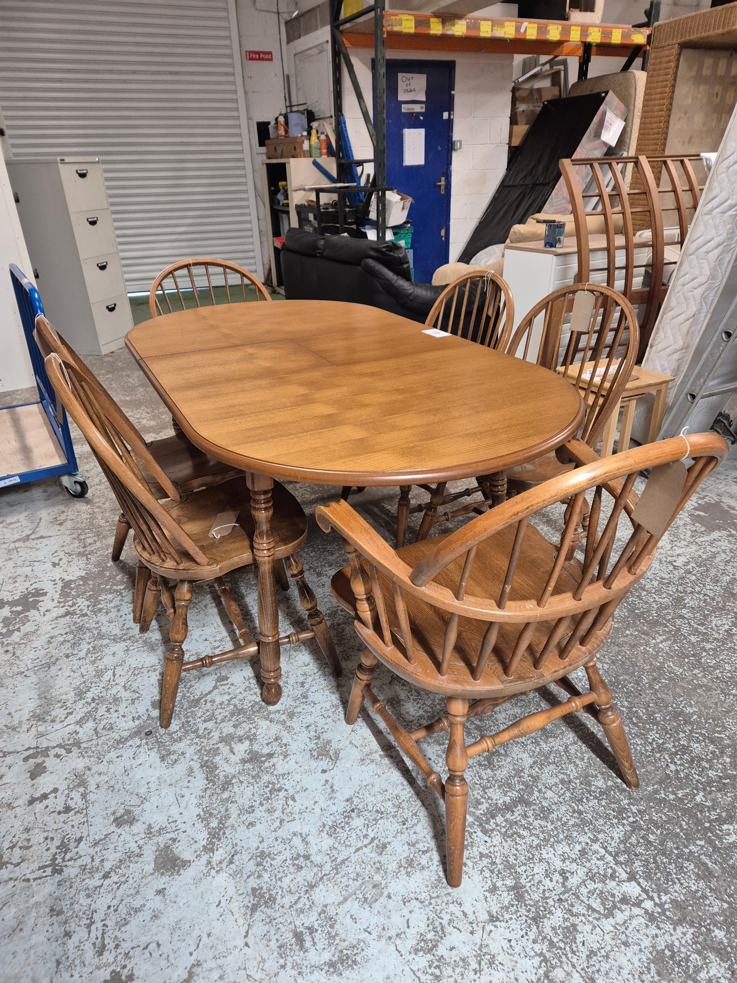 Solid oak stained extendable oval kitchen table with 4 no. matching chairs and 2 no. carvers  2125