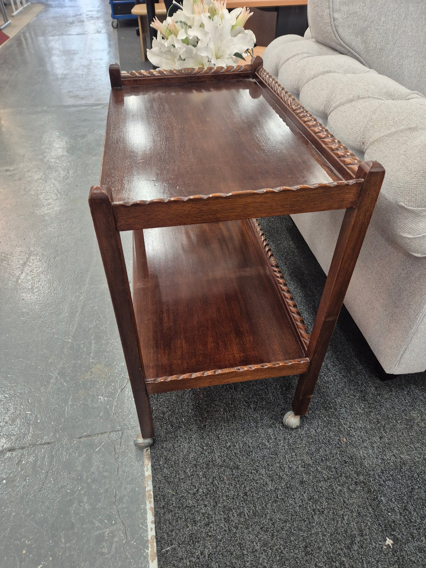 Tall mahogany tiered drinks trolley on castors 