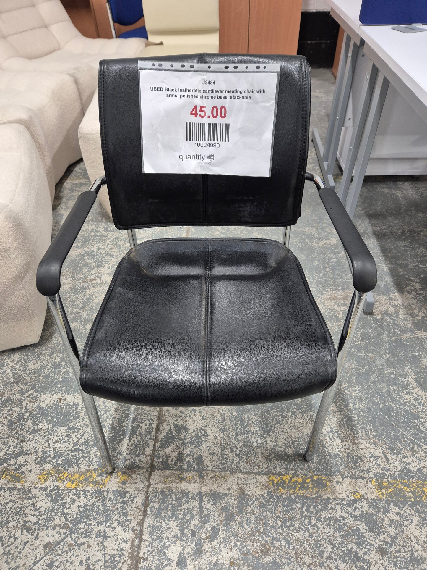 USED Black leatherette cantilever meeting chair with arms, polished chrome base, stackable